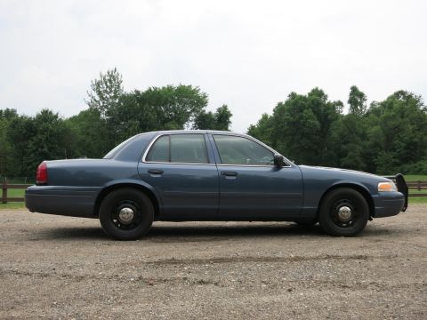 2001 Ford Crown Victoria - Blue 2001 Ford Crown Victoria police car seen from the side.