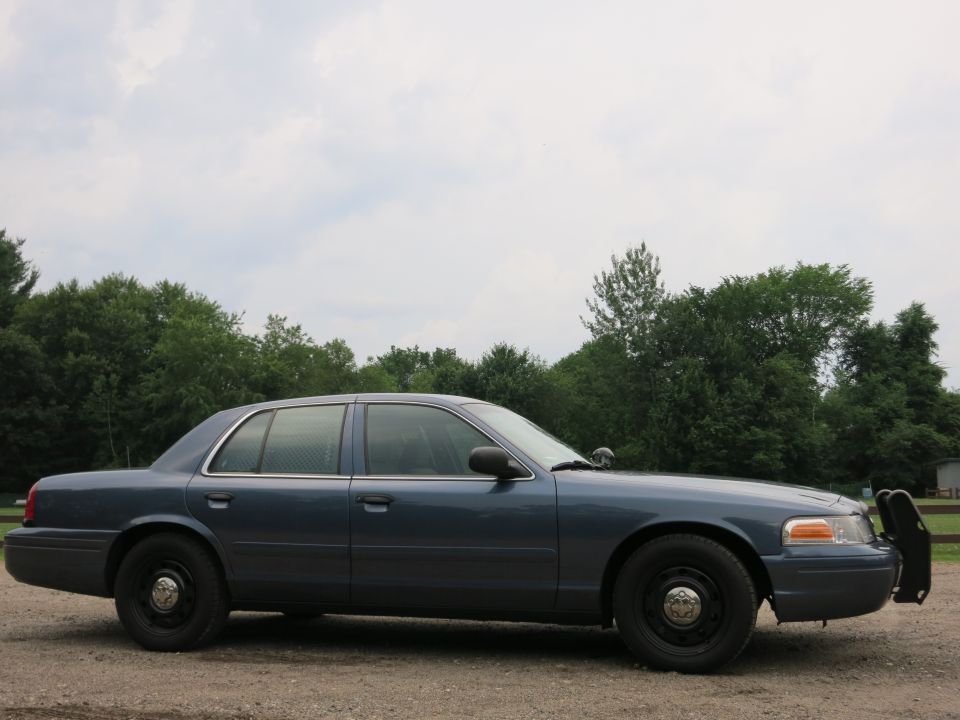 Blue 2001 Ford Crown Victoria police car, side view