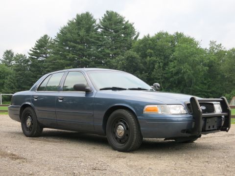 2001 Ford Crown Victoria - This 2001 Ford Crown Victoria, seen from a 3/4 front angle, features a prominent push bar on its front end.