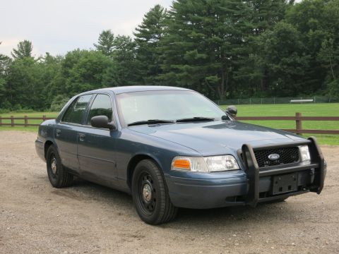 2001 Ford Crown Victoria - This 2001 Ford Crown Victoria, equipped with a front push bar, is seen from a three-quarter front view.