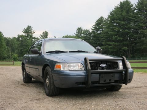 2001 Ford Crown Victoria - Front view of a blue 2001 Ford Crown Victoria police car with a push bumper.