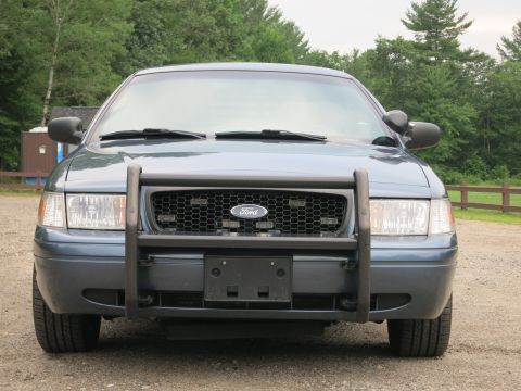 2001 Ford Crown Victoria - Front view of a blue 2001 Ford Crown Victoria equipped with a push bar.