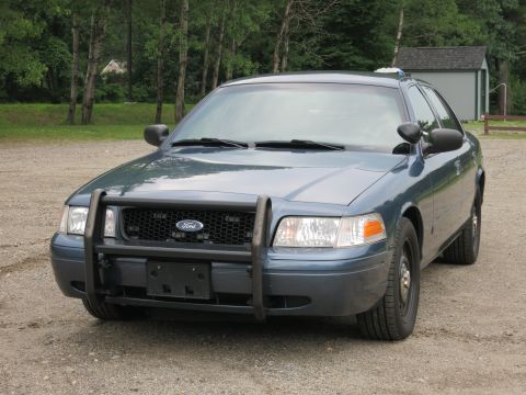 2001 Ford Crown Victoria - Front view of a Ford Crown Victoria police car with a push bar.