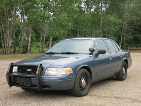 2001 Ford Crown Victoria - Front 3/4 view of a blue Ford Crown Victoria police car with a push bumper.