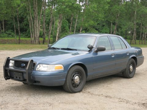2001 Ford Crown Victoria - This 2001 Ford Crown Victoria police car features a prominent push bumper and is viewed from the front quarter angle.