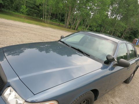 2001 Ford Crown Victoria - Front passenger side view of a blue 2001 Ford Crown Victoria.