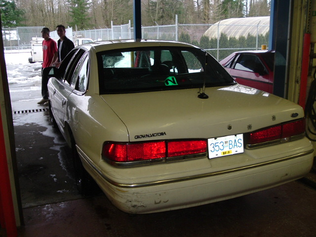 Cream Ford Crown Victoria sedan rear view with BC plate 353 BAS