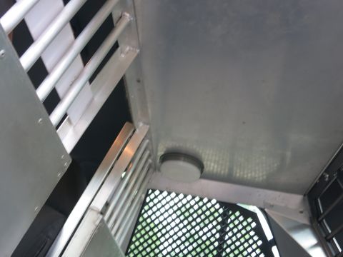 2001 Ford Crown Victoria - The interior of a vehicle is shown, metal bars and a circular light fixture on the ceiling.