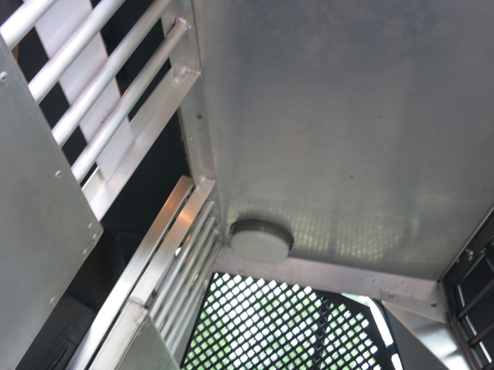 Interior of a vehicle with metal bars and a light fixture