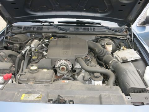 2001 Ford Crown Victoria - The engine bay of a 2001 Ford Crown Victoria, showing the V8 engine and associated components.