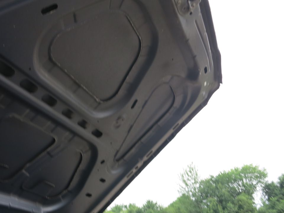 underside of car hood, showing bracing and insulation panels