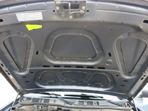 2001 Ford Crown Victoria - Underside of a car hood showing insulation and structural details.