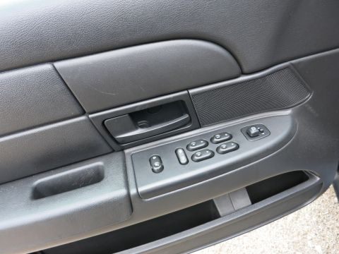 2001 Ford Crown Victoria - Close-up of a car's interior door panel, showing the window controls and handle.