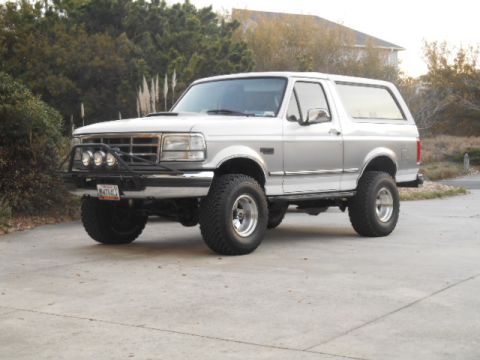 1994 Ford Bronco - This SUV features a lifted suspension and aggressive tires, suggesting it's built for off-road use.