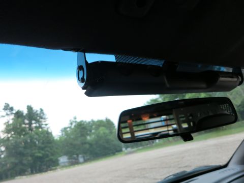 2001 Ford Crown Victoria - Interior view of a vehicle showing a dashcam and rearview mirror.