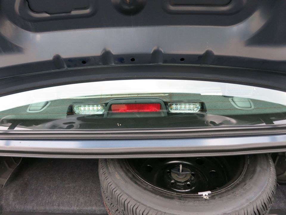 Spare tire and trunk liner visible inside a car's trunk