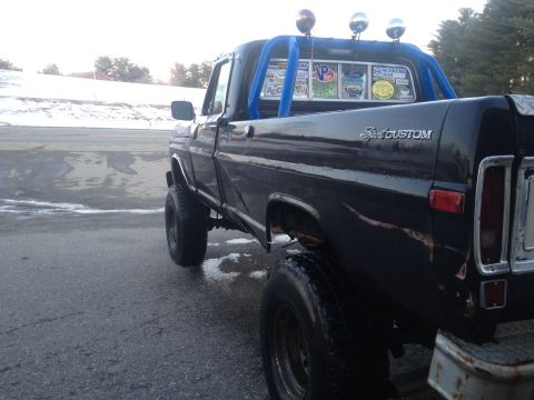 1970 Ford F-250 - This pickup truck has a custom look with a roll bar and aftermarket lights. The year is estimated based on its body style.