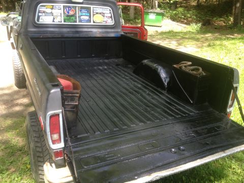 1970 Ford F-250 - The bed of a 1973 Ford F-100 pickup truck is shown with a black liner and some items in the bed.