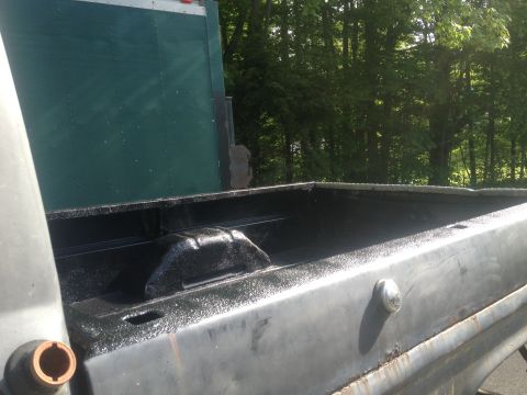 1970 Ford F-250 - The bed of a truck has been lined with a black protective coating.