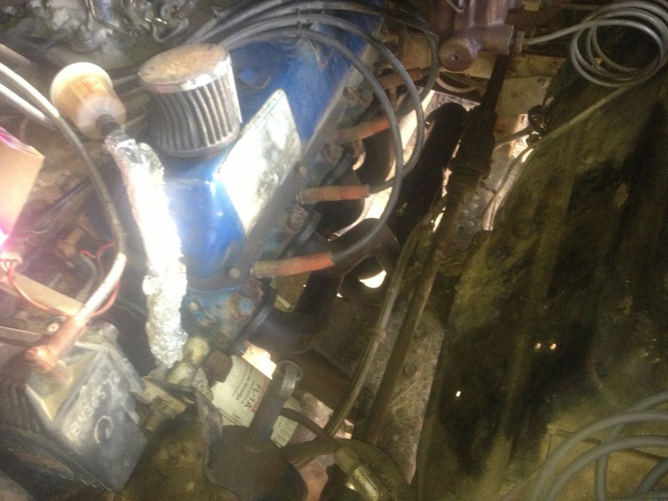 Engine bay shot showing blue valve covers, air filter, and wiring