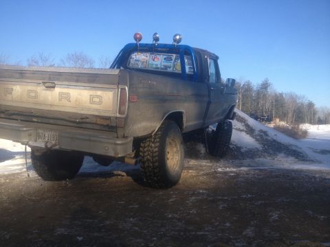 1970 Ford F-250 - This 1970 Ford F-250 pickup truck is equipped with a roll bar and large off-road tires, seen here on a dirt and snow-covered incline.