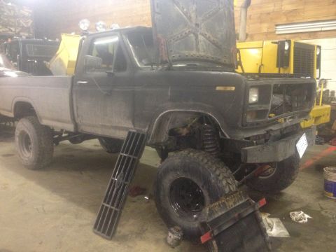 1970 Ford F-250 - This Ford F-Series pickup truck appears to be undergoing repairs or modifications in a garage setting.