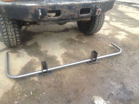 1970 Ford F-250 - Custom rear bumper part laid out on the ground near a vehicle's rear end.