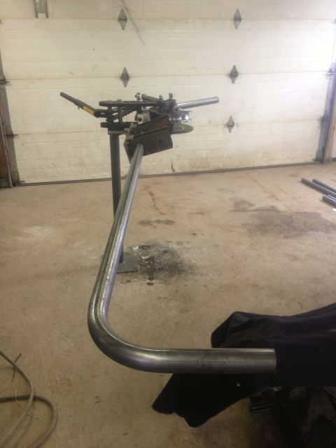 1970 Ford F-250 - A tube bending machine is shown with a pipe that has been bent into a curve.