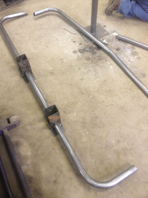 1970 Ford F-250 - Metal tubing components are laid out on a concrete surface, possibly for assembly or repair.