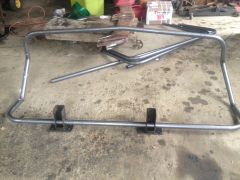 1970 Ford F-250 - A custom-fabricated roll bar frame is shown on a concrete floor in a workshop setting.