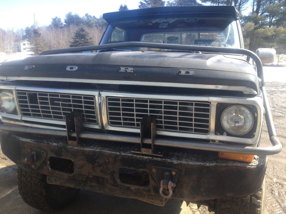 Front view of a 1970 Ford F-250 with a custom brush guard and roof-mounted light bar