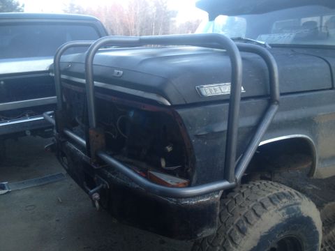 1970 Ford F-250 - This Ford truck features a heavy-duty aftermarket bumper and grille guard, with another vehicle partially visible to the left.