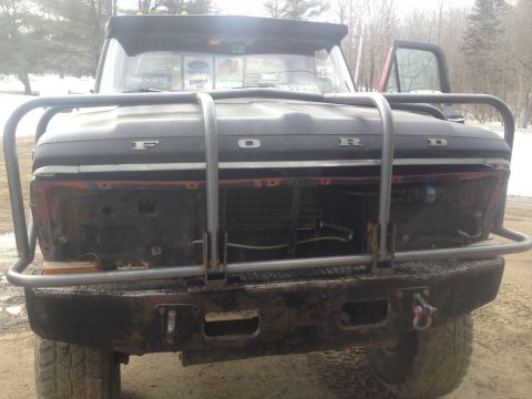 1970 Ford F-250 - Front view of a 1970 Ford F-250 pickup truck a prominent bull bar and a partially removed grille.