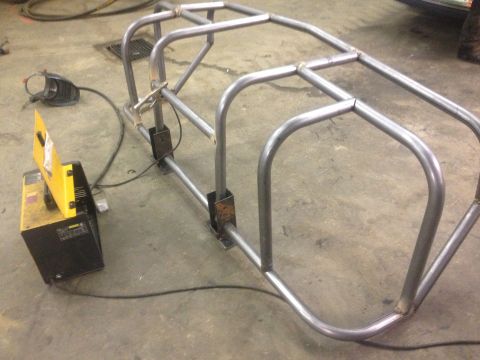 1970 Ford F-250 - A custom roll cage is being fabricated, showing the raw metal tubing and welding setup.