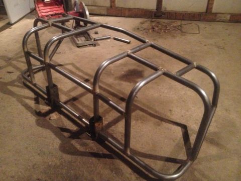 1970 Ford F-250 - A custom roll cage frame is shown in a workshop setting.