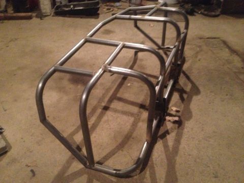 1970 Ford F-250 - A custom-built metal roll cage frame is shown indoors on a concrete floor.