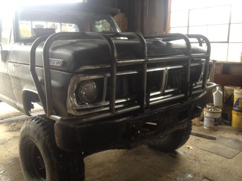 1970 Ford F-250 - This 1970 Ford F-250 features a heavy-duty custom bull bar and is equipped with large off-road tires.