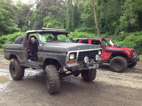 1979 Ford Bronco - This lifted 1979 Ford Bronco is ready for adventure, seen here alongside a red Jeep in an outdoor setting.