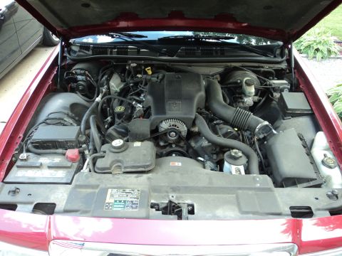 2004 Mercury Grand Marquis - Engine bay of a 2004 Mercury Grand Marquis, showing the V8 engine and associated components.