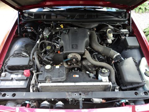 2004 Mercury Grand Marquis - The engine compartment of a 2004 Mercury Grand Marquis is shown with the hood open.
