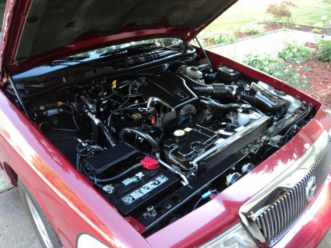 2004 Mercury Grand Marquis - Engine bay of a 2004 Mercury Grand Marquis, showing the V8 engine and battery.