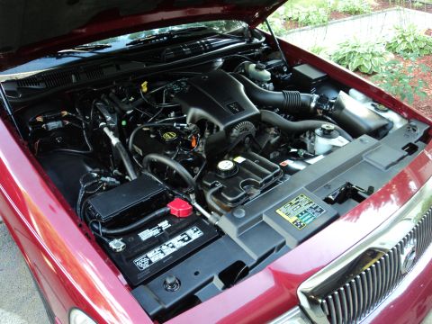 2004 Mercury Grand Marquis - The engine bay of a 2004 Mercury Grand Marquis, showing the engine and battery.