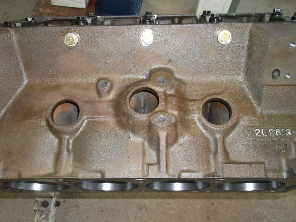 Close-up of an engine block with visible casting marks and part numbers