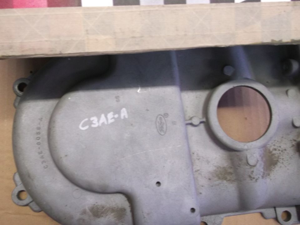 Close-up of a metal engine part with "C3AE-A" and a Ford logo stamped on it