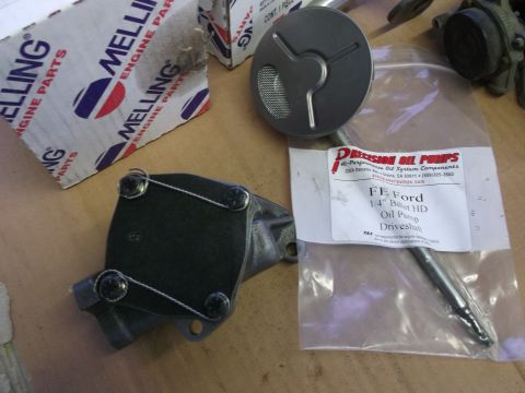 1963 Ford Galaxie - Engine oil pump and related parts are laid out on a surface, with Melling and Precision Oil Pumps branding visible.