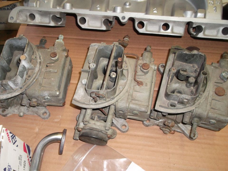 three carburetors and an intake manifold