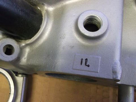 1963 Ford Galaxie - Close-up of an engine part with visible machining marks and a handwritten label.
