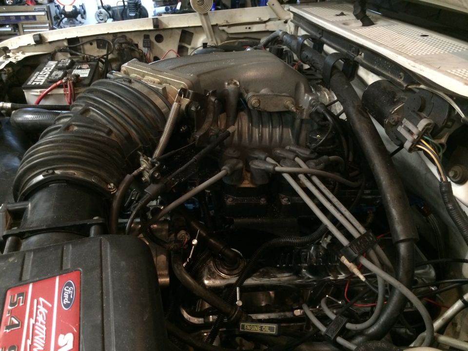 Ford 5.4L Lightning engine with supercharger, air intake, and battery