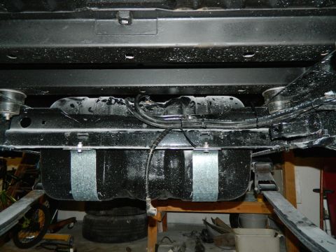 1979 Ford Bronco - Undercarriage view shows a fuel tank secured with metal straps, with visible hoses and wiring.