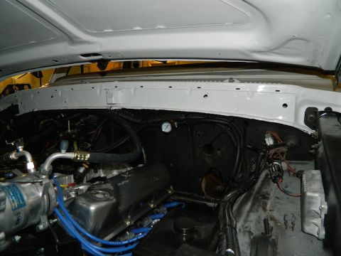 1979 Ford Bronco - The engine bay of a vehicle is shown with various components and wiring visible.